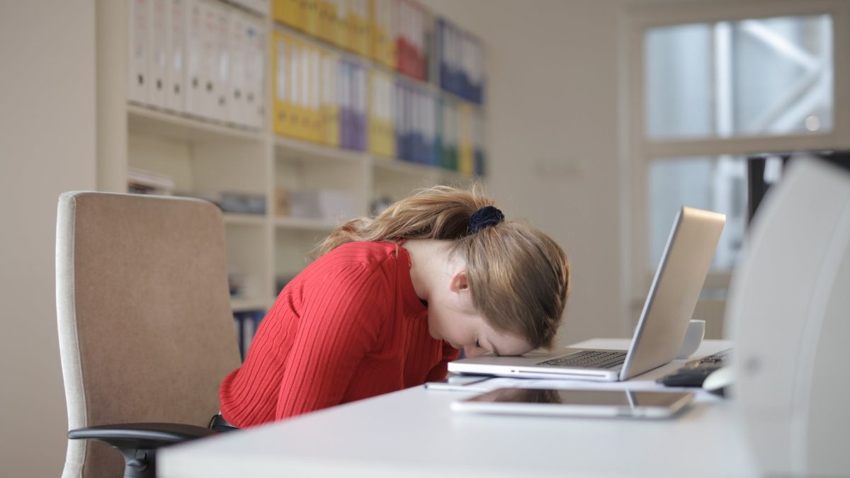 woman sitting on chair while leaning on laptop